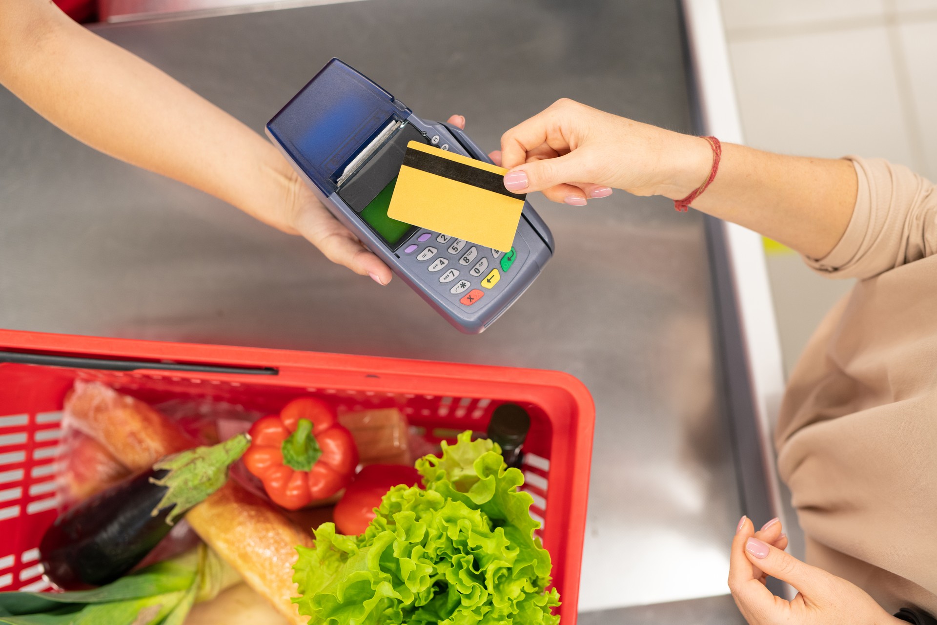 Woman Paying For Things In Supermarket